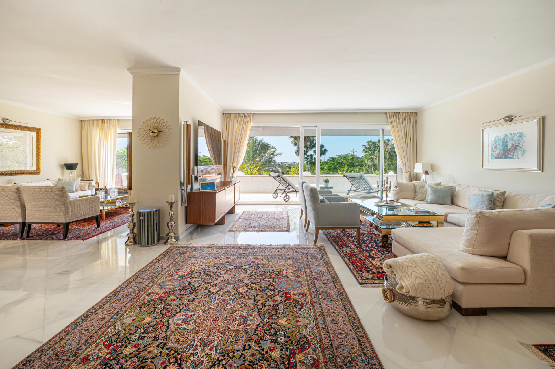 Sitting and dining room with marble floors opening to the main terrace