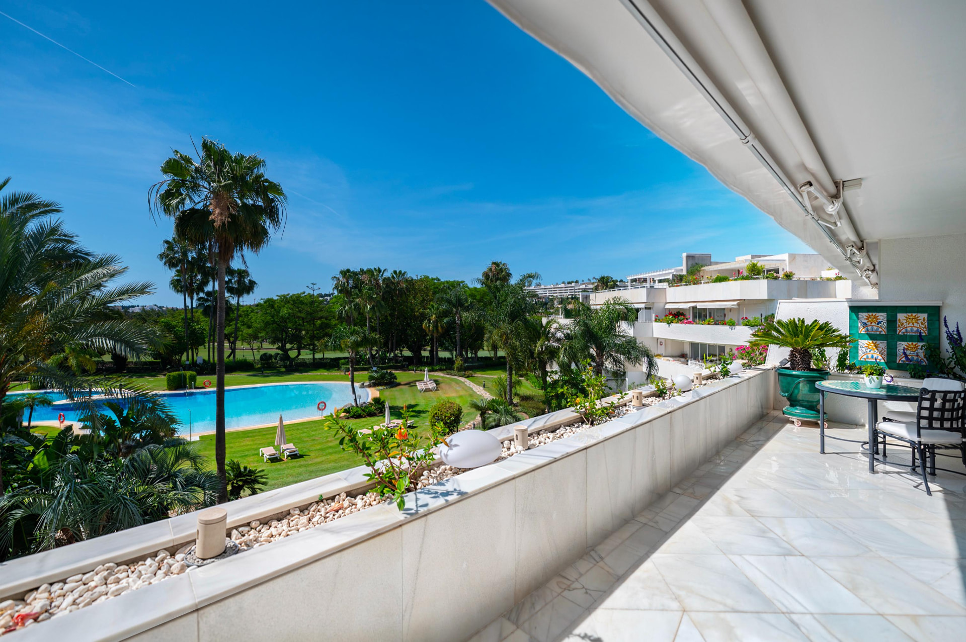 Covered main terrace overlooking the gardens and community pool