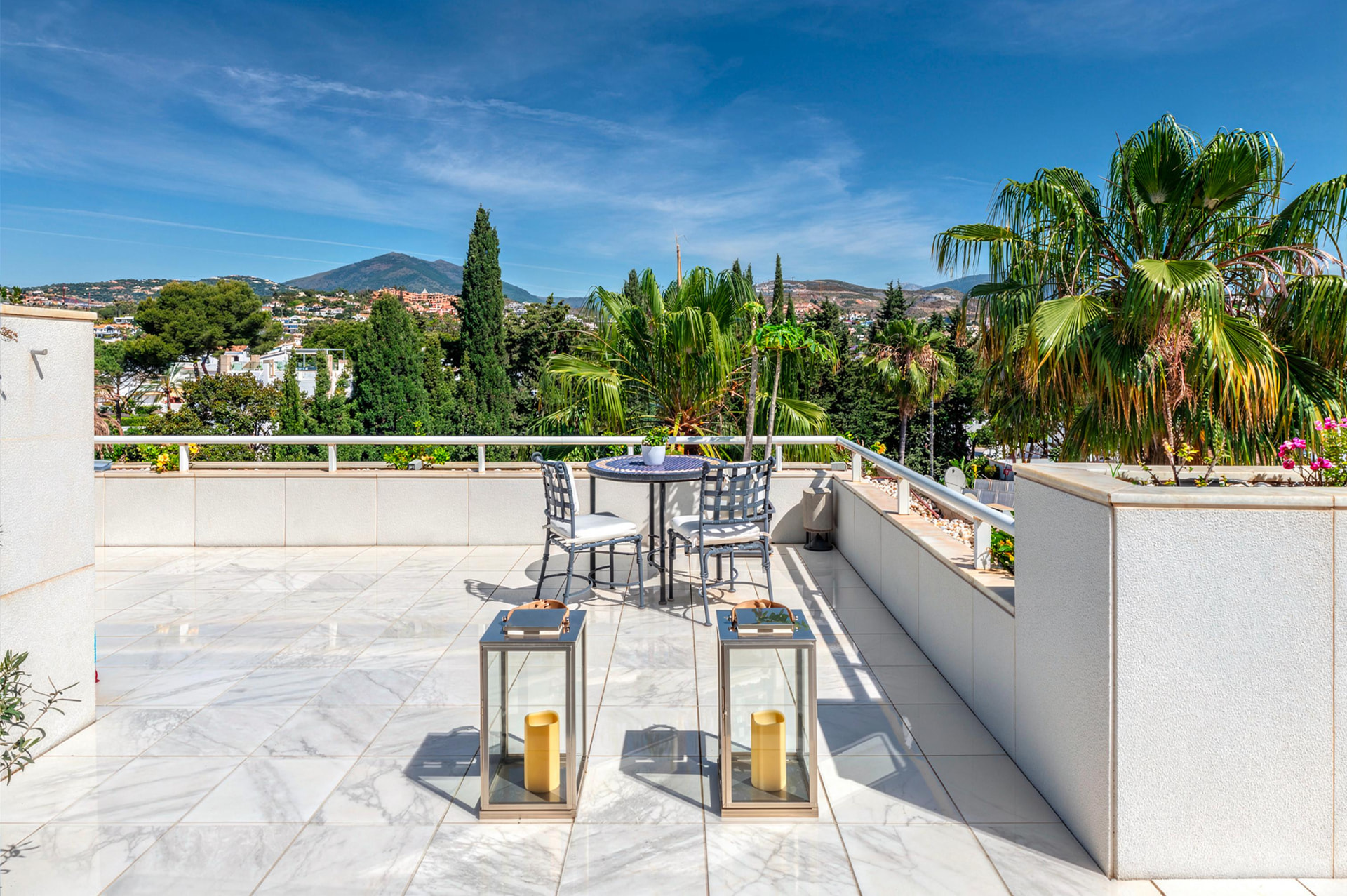 Marble roof terrace with dining table and views towards the mountains