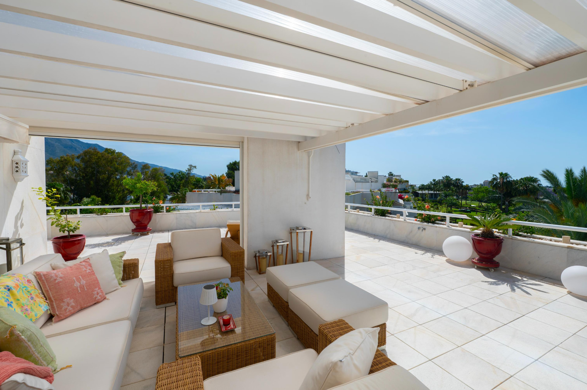 Pergola-covered terrace lounge with mountain and golf course views